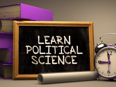 Learn Political Science. Inspirational Quote Hand Drawn on Chalkboard. Blurred Background. Toned Image.